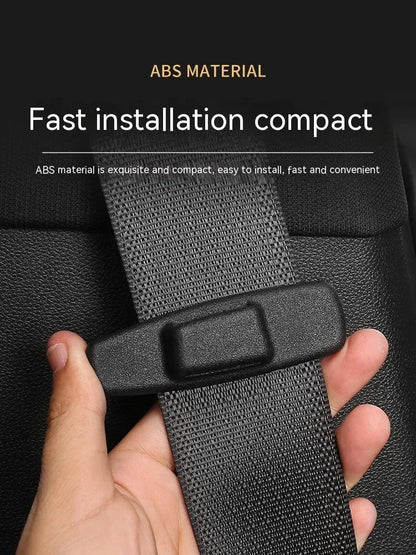 Two black ABS plastic car seat belt stopper clips in clear OPP packaging