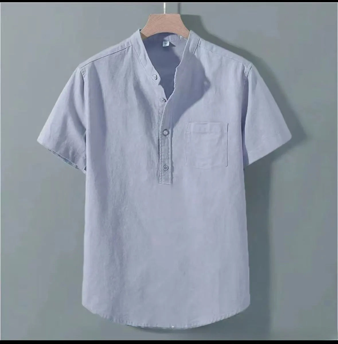 Men's casual beige linen-cotton shirt with stand collar and short sleeves on a hanger