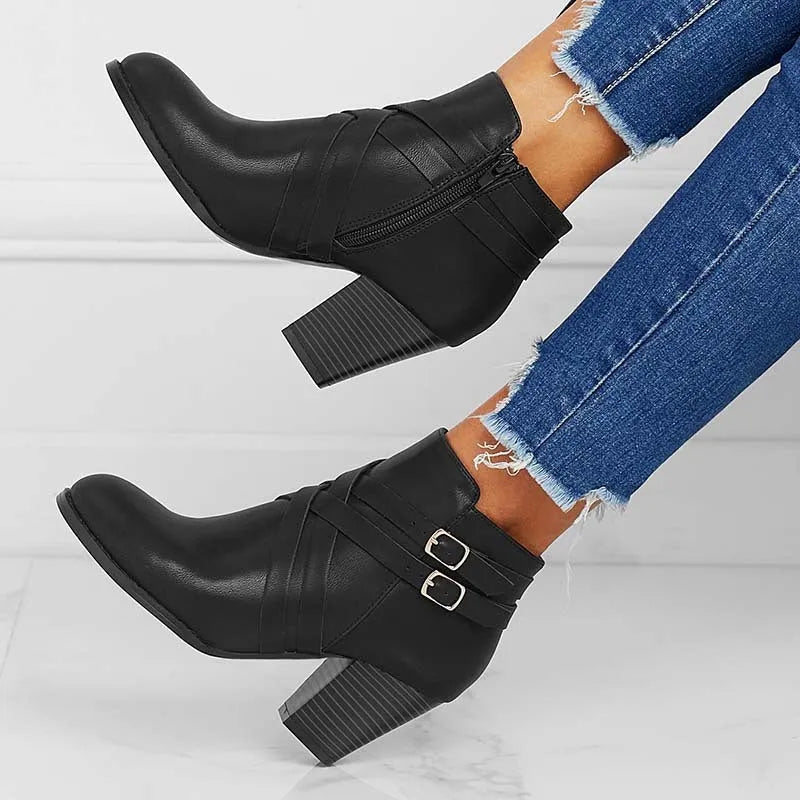 Women's short ankle boots with a belt buckle and side zip in black, brown, or grey with a 7cm heel.
