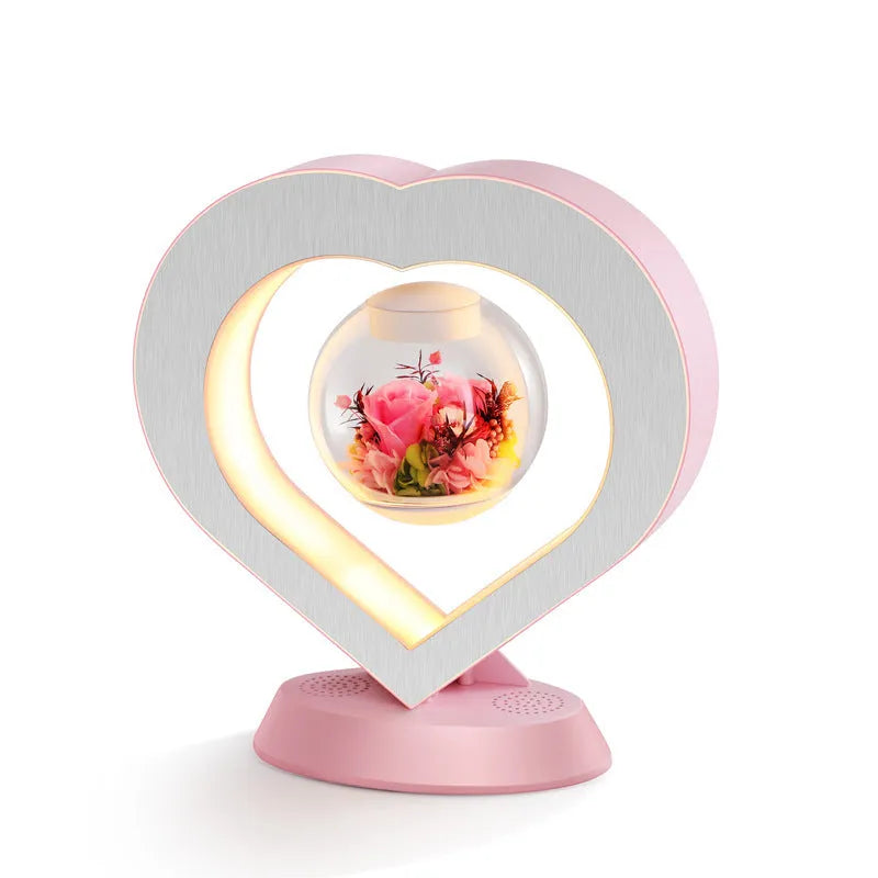 Pink rose eternal flower floating in magnetic levitation LED night light with triangular base and touch control