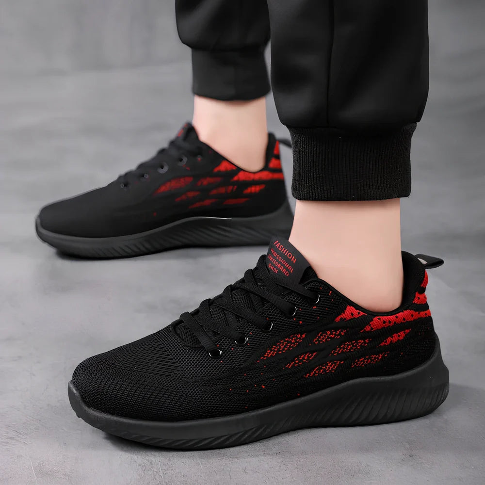 Men's black mesh sports shoes with red accent details and flexible PVC sole construction