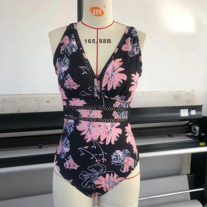 Black plus size bikini swimsuit with print design for women, shown on a hanger.