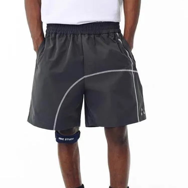Men's dark grey loose fit drawstring shorts made from high elasticity polyester fabric.