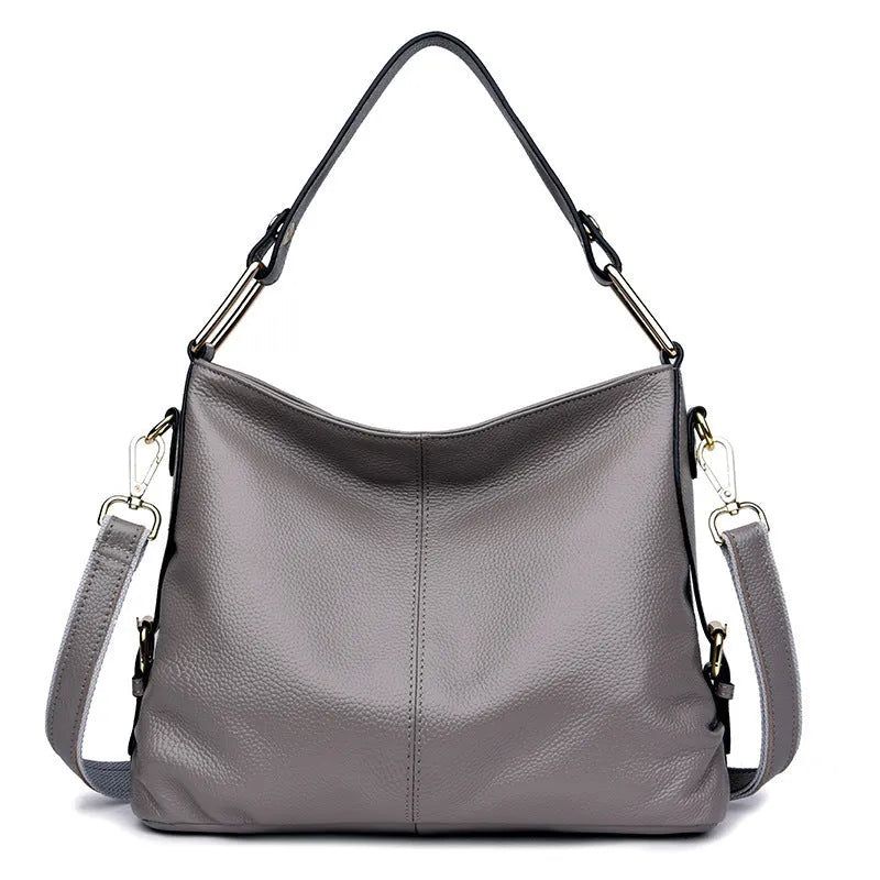 Black genuine leather vertical crossbody bag with multiple internal compartments and a sandwich pocket.