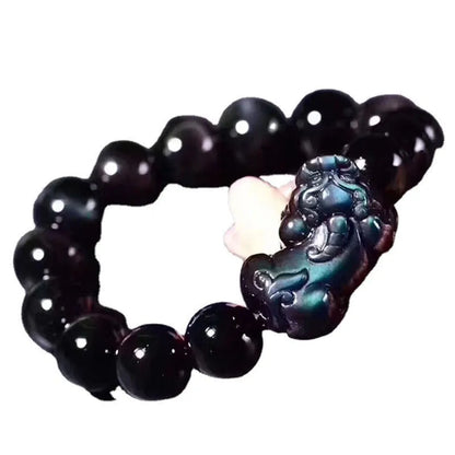 Natural Ice Colour Eye Obsidian crystal bracelet on wrist, showing translucent beads.