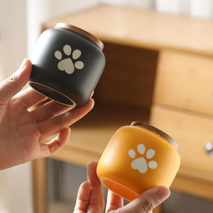Ceramic pet funeral urn with foot print design in choice of colours and 180ml or 500ml sizes