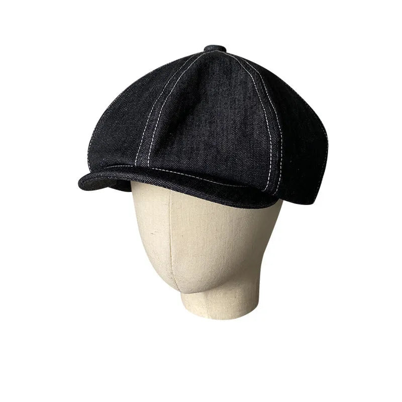 Black Japanese denim cotton beret hat showing octagonal cap style on neutral background