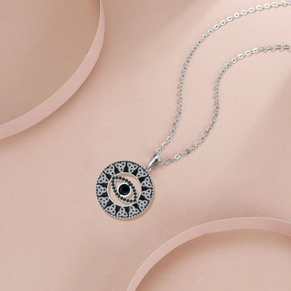 Close-up of a women's copper Devil's Eye pendant necklace on a cross chain, showing electroplated finish.