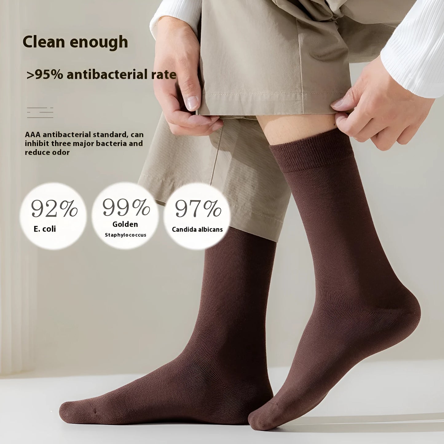 Pair of solid-colour men's mid-calf socks made from combed cotton on a wooden background
