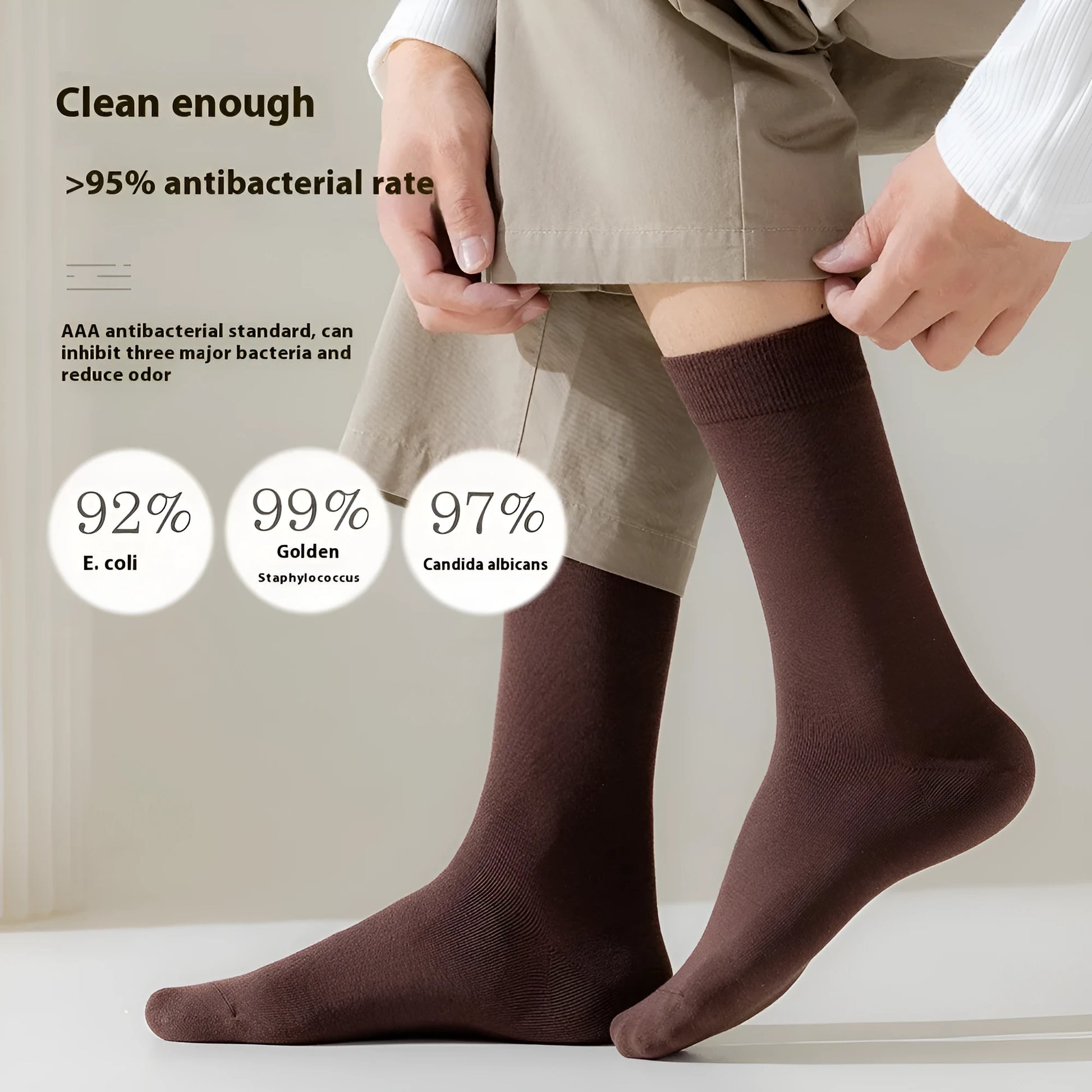Pair of solid-colour men's mid-calf socks made from combed cotton on a wooden background