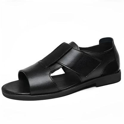 Men's brown leather Roman sandals with an open toe and rubber sole on a wooden surface.