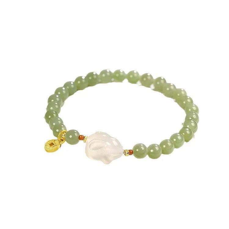 Handmade women's bracelet with a glass rabbit charm on a coloured glaze chain.