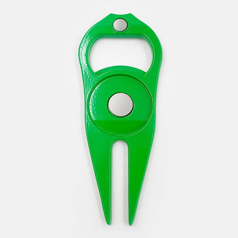 Black zinc alloy golf ball fork and bottle opener tool on a putting green.