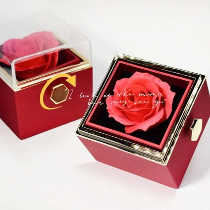 Rotating rose jewellery gift box with a preserved red rose under a clear acrylic dome, showing the interior rotating drawer.