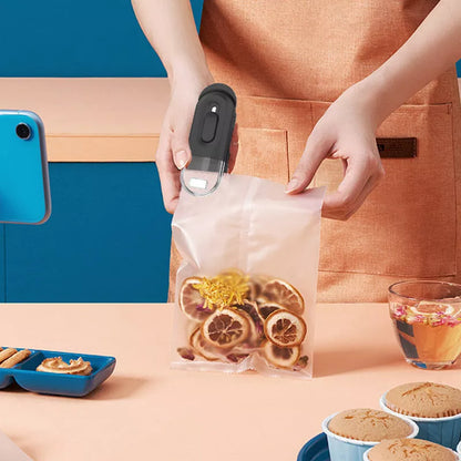 Handheld portable food bag sealer in black, white, or lake blue with sealing and cutting functions