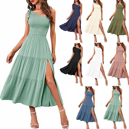 Elegant one-shoulder pleated maxi dress in various colours, featuring an asymmetrical hem and side slits for a stylish, head-turning look