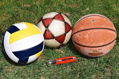 Portable air pump for basketball, football, and volleyball with double-action mechanism