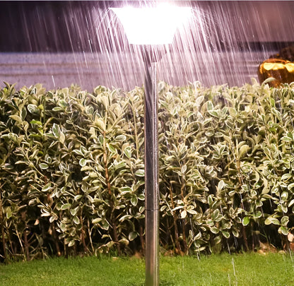 Solar-powered outdoor street light with solar panel on top and LED light fixture.