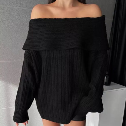 Woman wearing a loose white acrylic knit pullover sweater with long sleeves and an off-neck design.