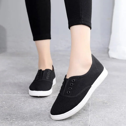 A pair of low-top canvas casual trainers in a choice of colours, shown on a flat surface.