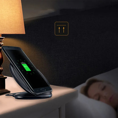 Black Qi wireless charging pad for Samsung Galaxy Note Edge on a desk.