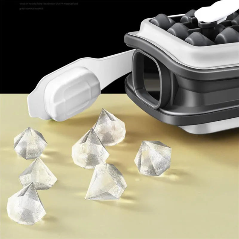 Light grey silicone ice ball mould and water bottle with lid on a kitchen counter.