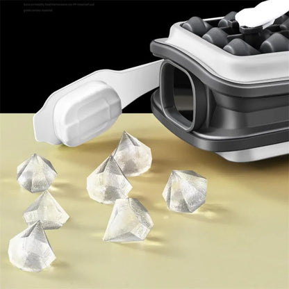 Light grey silicone ice ball mould and water bottle with lid on a kitchen counter.