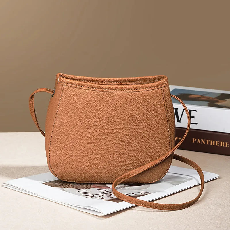 Women's genuine cowhide leather messenger bag showing organisational compartments and sandwich pockets in neutral colour