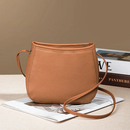 Women's genuine cowhide leather messenger bag showing organisational compartments and sandwich pockets in neutral colour