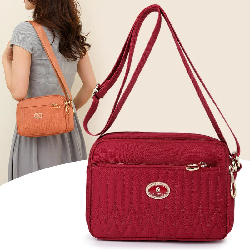 Compact nylon messenger bag for women in various colours with adjustable strap