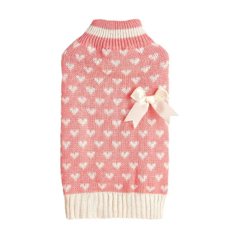 Dog wearing red love heart design sweater with bow decoration