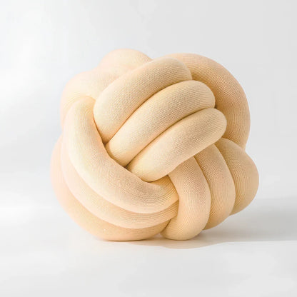 Knotted lumbar pillow with memory foam fill showing adjustable height feature and polyester cover