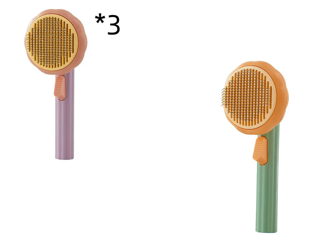 Hand-held pumpkin-coloured pet brush with stainless steel needles for grooming cats and dogs