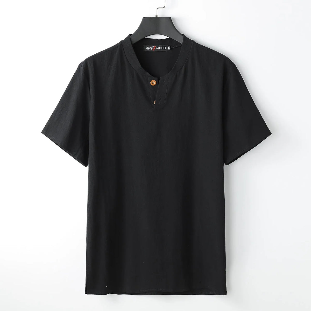 Women's loose fit apricot cotton V-neck short sleeve pullover top on a hanger.