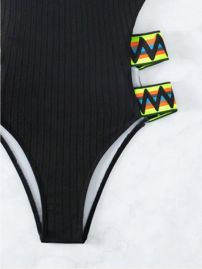Women's one-piece swimming suit bikini in solid black or orange, made from polyester fabric, showing front view