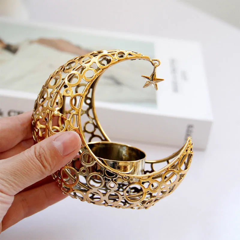 Metal crescent moon candle holder for tealight candles in black or gold colour on desktop