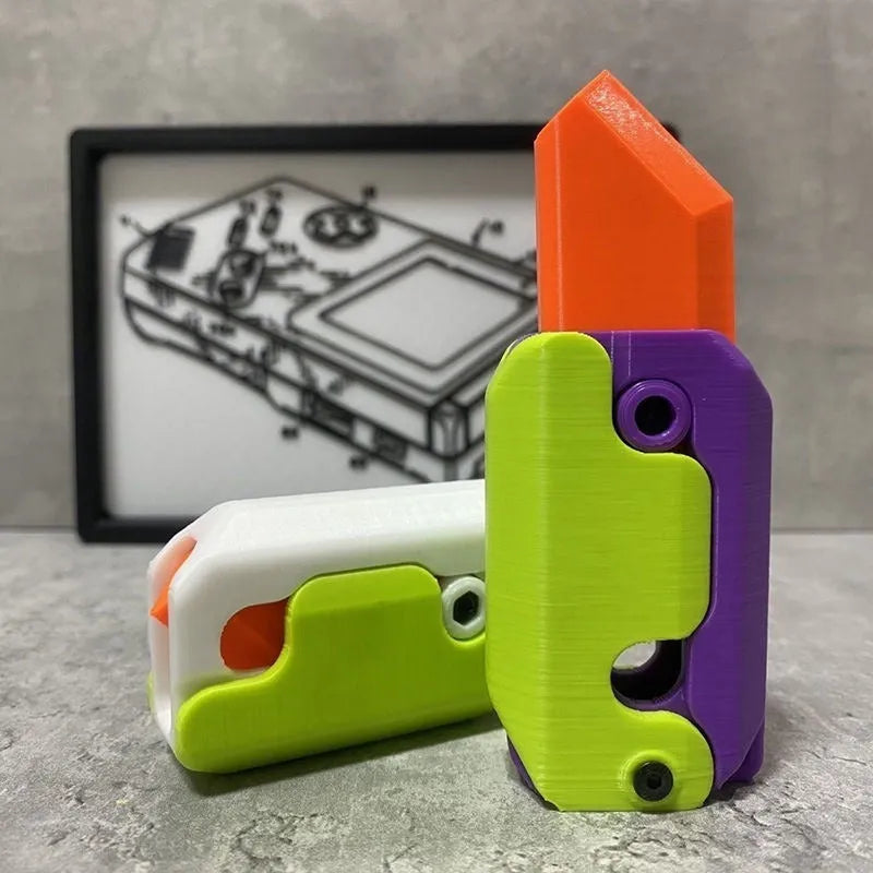 3D printed plastic carrot fidget knife with retractable blade, shown in orange and green colour scheme.