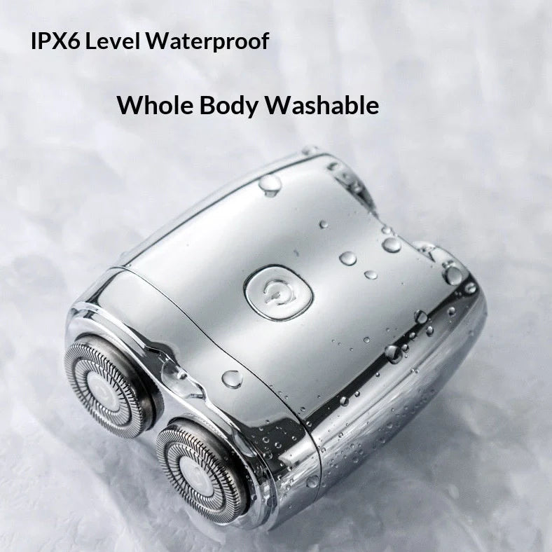 Silver portable electric shaver with floating double cutter heads, USB charging port, and rubberised grip