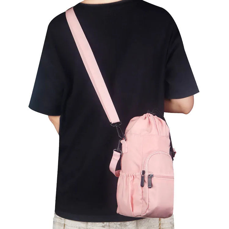 Black cloth crossbody water bottle pouch bag holding a reusable flask.