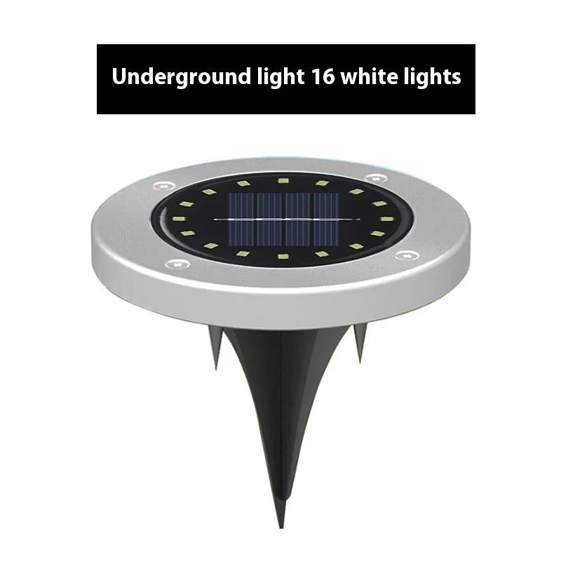 Stainless steel solar garden ground lamp installed in a lawn.