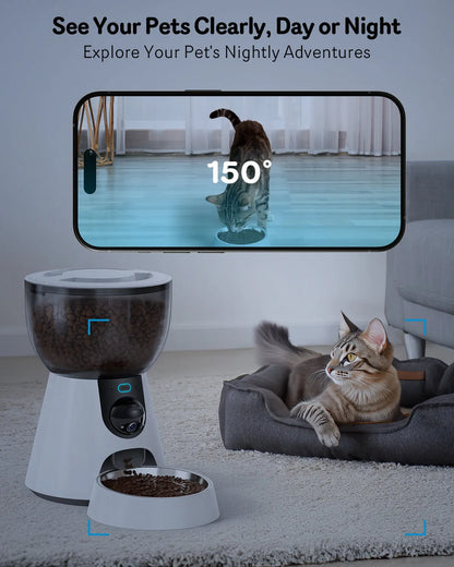 Automatic cat feeder with built-in camera on kitchen floor next to food bowl.