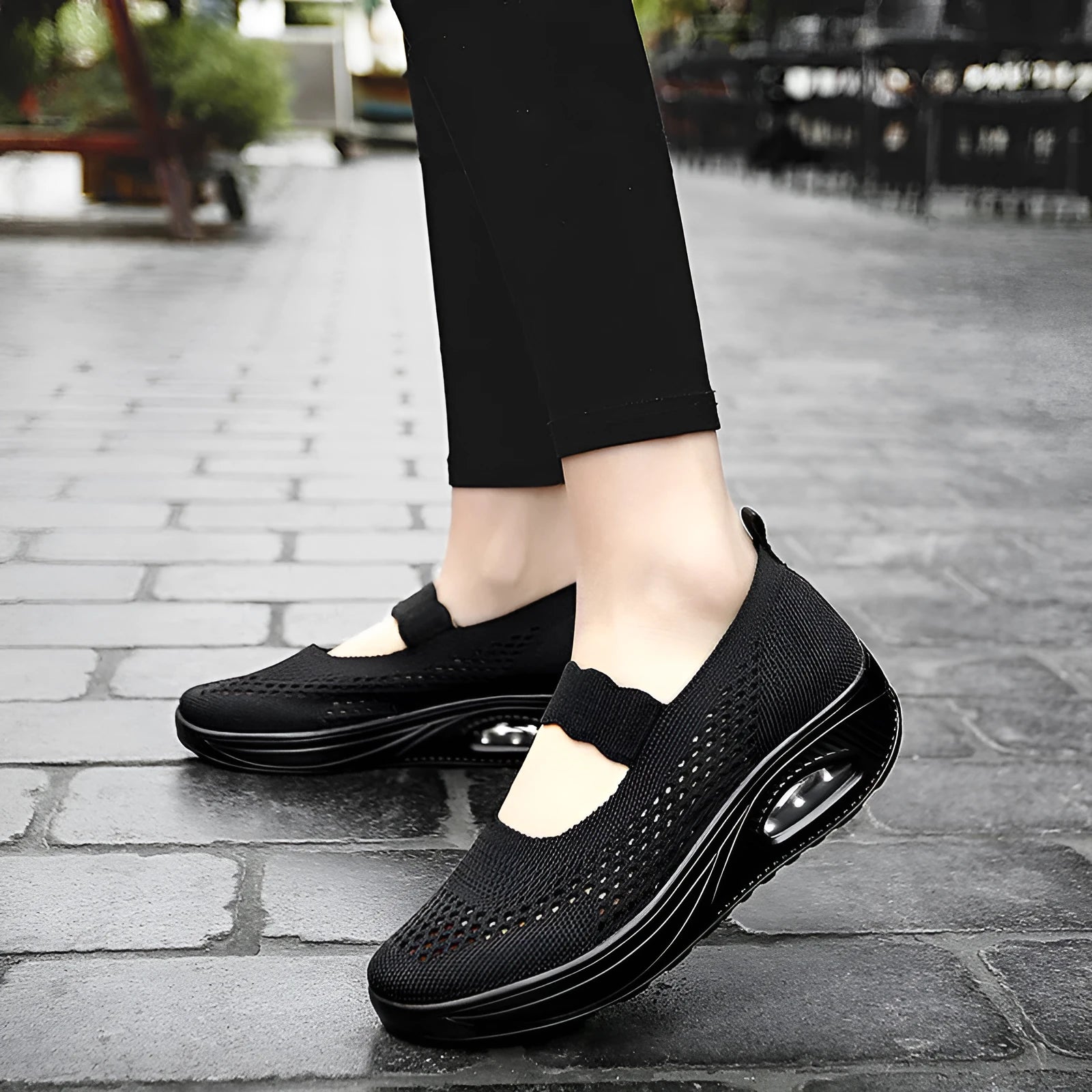 Women's black mesh slip-on casual shoes with round toe and low heel on white background