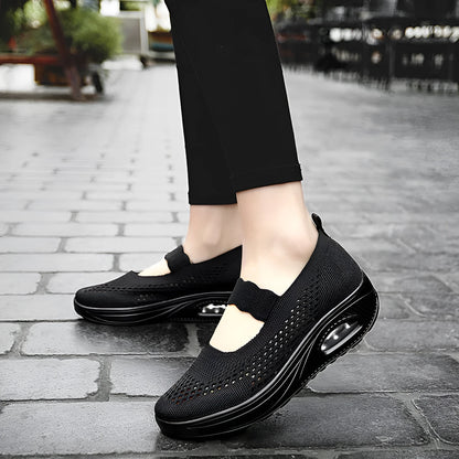 Women's black mesh slip-on casual shoes with round toe and low heel on white background