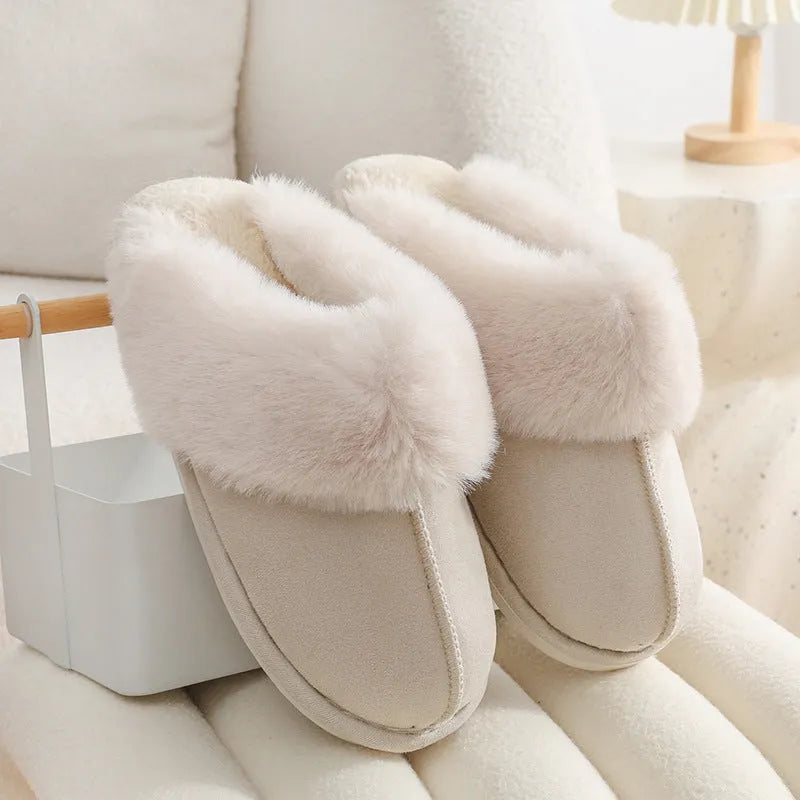 Women's plush winter slippers with round toe, flat heel, and stitching detail on a non-slip PVC sole.
