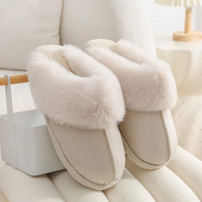 Women's plush winter slippers with round toe, flat heel, and stitching detail on a non-slip PVC sole.
