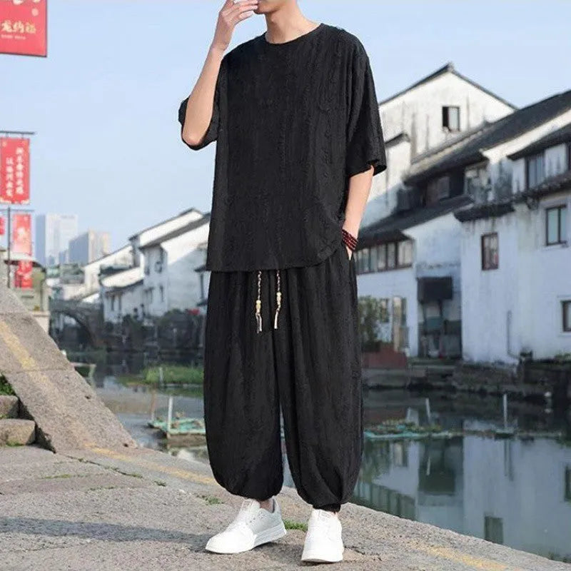 Men's thin knit two-piece suit with half-sleeve top and cropped trousers in black or grey colour options