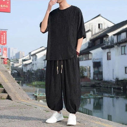 Men's thin knit two-piece suit with half-sleeve top and cropped trousers in black or grey colour options