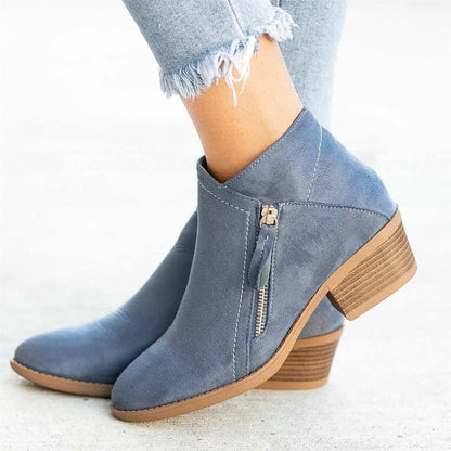 Women's suede ankle boots with a side zip and chunky heel in beige, shown from the side.