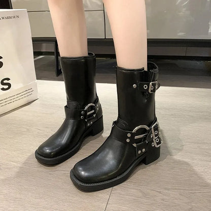 Women's black platform ankle boots with a silver buckle on the shaft, shown in a middle-calf length style.