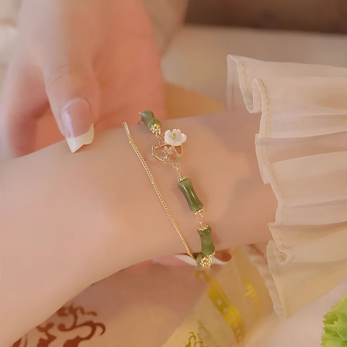 Natural olivine bracelet with Chinese double layer design featuring twin bells of Ireland olive branch elements